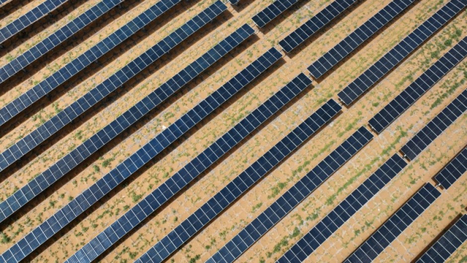 An aerial view shows solar panels at the fishing-solar complementary photovoltaic power generation base in Lianyungang, in eastern China's Jiangsu province