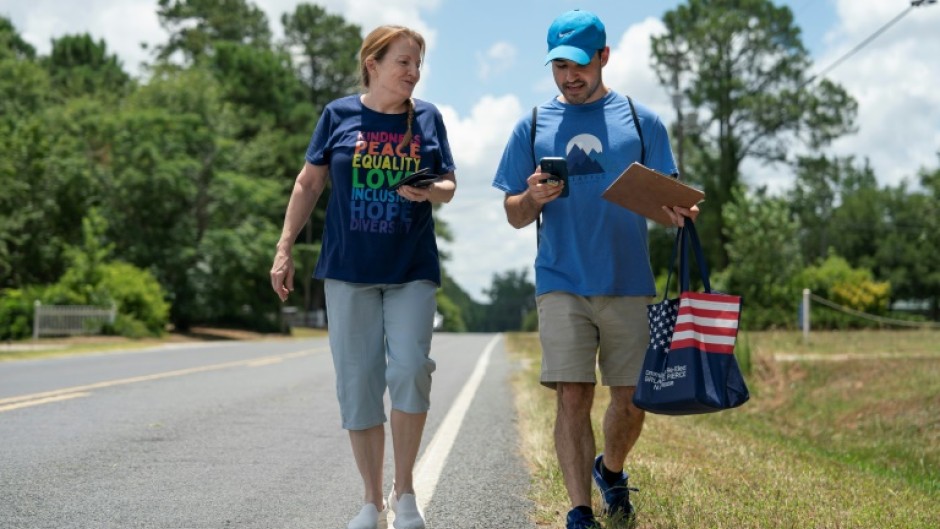 Democratic Party activists Darah Hardy (L) and Yampiere Lugo (R) canvass voters in Laurinburg, North Carolina