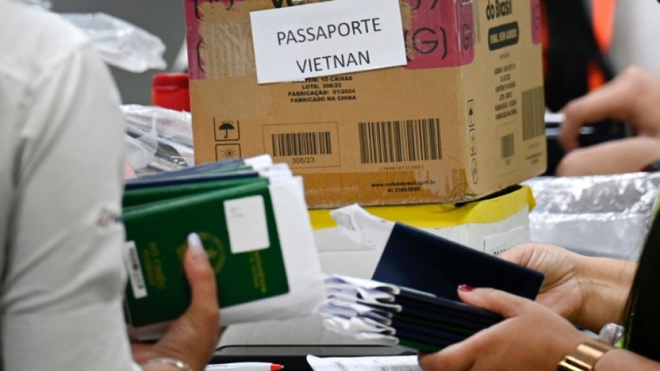  Staff at Guarulhos International Airport group passports of Indian and Vietnamese migrants seeking asylum