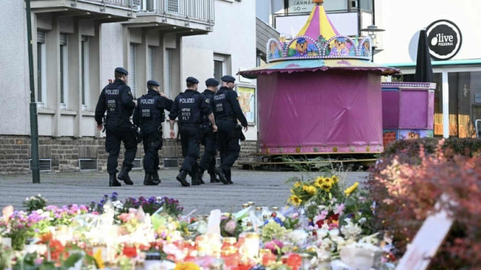 German police patrol after a knife attack that has added to a bitter debate over immigration