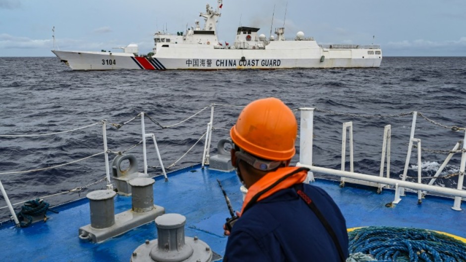 A China Coast Guard ship is seen from a Philippine Coast Guard vessel during a supply mission to Sabina Shoal earlier this month