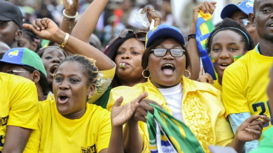 Crowds cheering at a parade to mark the anniversary 