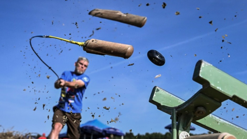 A player splits the wooden end of his stick while striking the hornuss