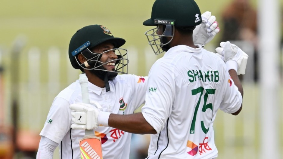 Bangladesh's Mushfiqur Rahim (L) and Shakib Al Hasan celebrate after winning the second Test