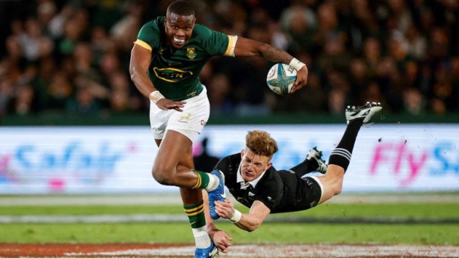 New Zealand's Damian McKenzie (R) tackles South Africa's Aphelele Fassi during their Rugby Championship match last week