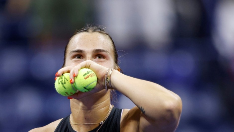 Crowd favourite: Aryna Sabalenka prepares to throw signed tennis balls to fans after defeatng Zheng Qinwen 