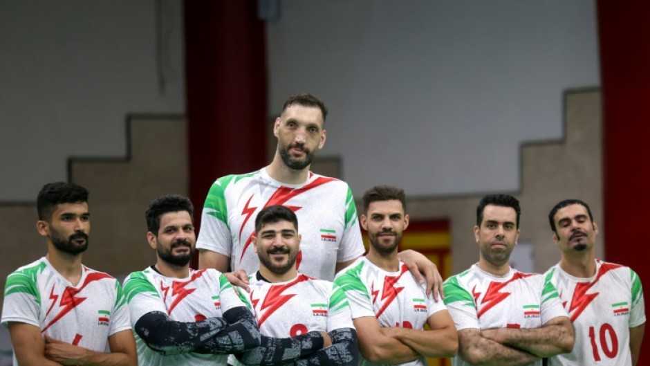 Morteza Mehrzad towers over with his teammates during a training session of Iran's national sitting volleyball team in July in Tehran 