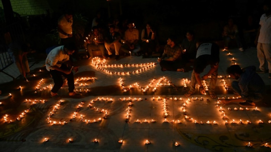 Health professionals light up earthen lamps in Kolkata calling for justice after the rape and murder of a doctor at a state-run hospital 