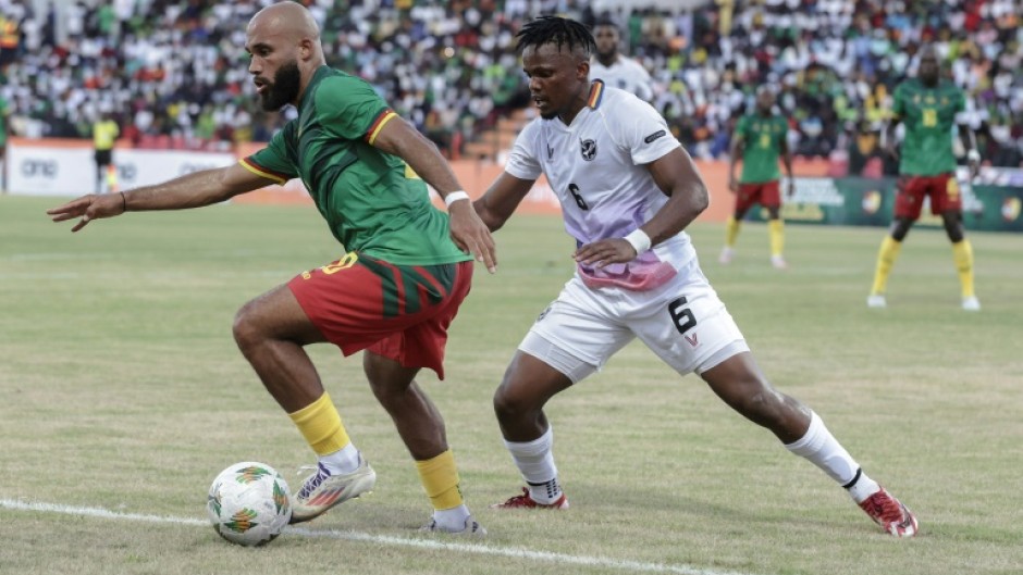 Cameroon forward Bryan Mbeumo (L) shields the ball from Namibia defender Ngero Katua during a 2025 Africa Cup of Nations qualifier in Garoua.
