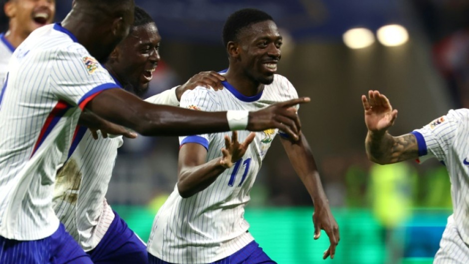 Ousmane Dembele (C) celebrates with teammates after scoring France's second goal against Belgium in Lyon