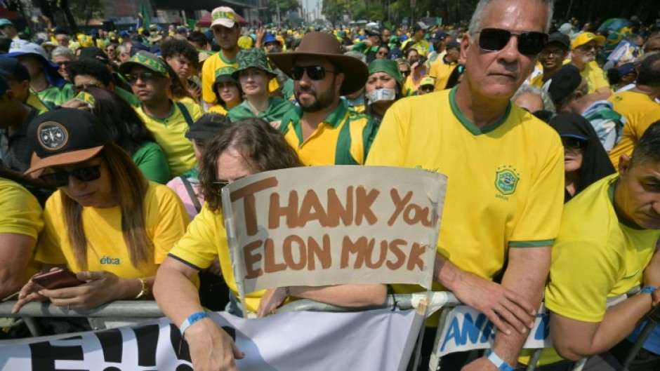 Supporters of former Brazilian President Jair Bolsonaro (2019-2022) hold a sign thanking X social media platform owner Elon Musk, during an Independence day rally in Sao Paulo, Brazil on September 7, 2024