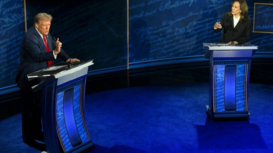 US Vice President and Democratic presidential candidate Kamala Harris (R) and former US President and Republican presidential candidate Donald Trump speak during a presidential debate in Philadelphia, Pennsylvania, on September 10, 2024
