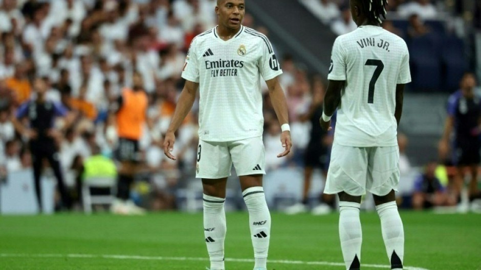 Real Madrid coach Carlo Ancelotti said strikers Kylian Mbappe (L) and Vinicius Junior (R) are "training well, happy" after an underwhelming start to the season