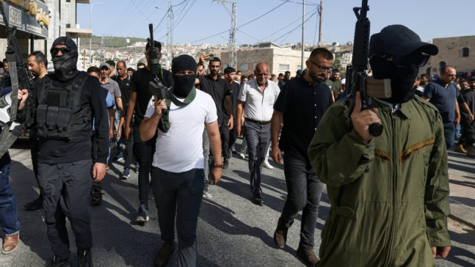 Palestinian militants take part in the funeral procession of men killed in an Israeli air strike in Tubas, in the occupied West Bank