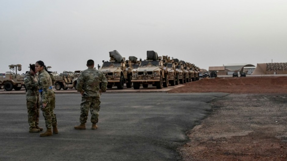 Military vehicles that will be boarded onto a cargo plane as part of US troops' departure from Niger are seen in Niamey in June 2024 