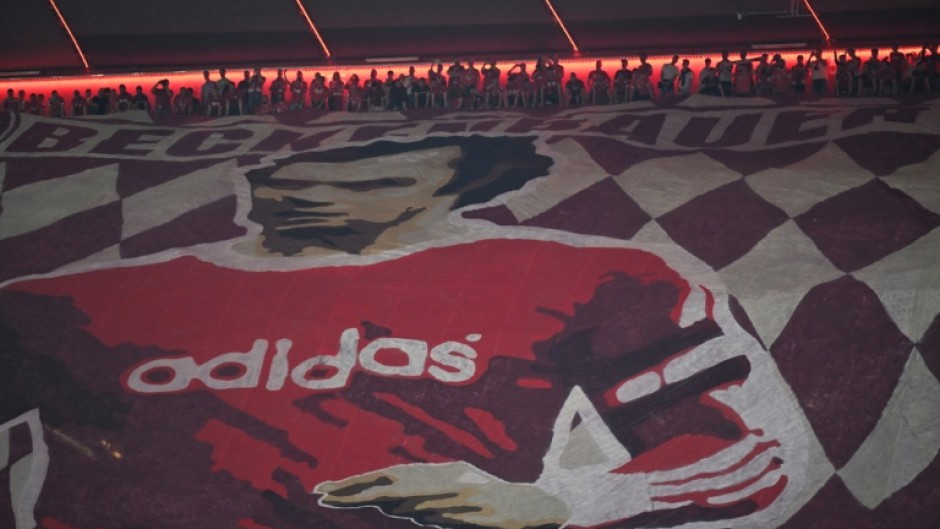 Bayern Munich fans display a banner depicting late football player Franz Beckenbauer at their Allianz Arena home