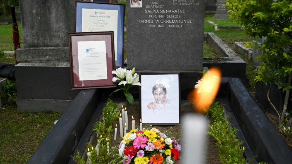 Flowers and candles at the gravesite of slain journalist Lasantha Wickrematunge on the 12th  anniversary of his death in 2021 