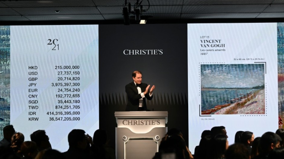 Bids are taken on "Les canots amarrés" by Vincent Van Gogh at a Christie's auction in Hong Kong