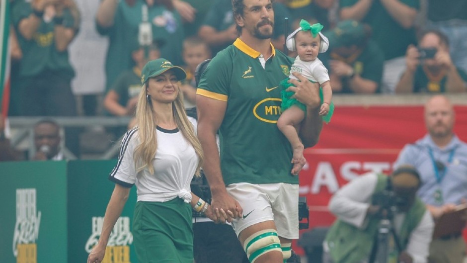 South Africa lock Eben Etzebeth walks on to the Mbombela Stadium pitch accompanied by his wife, Anlia, and baby daughter