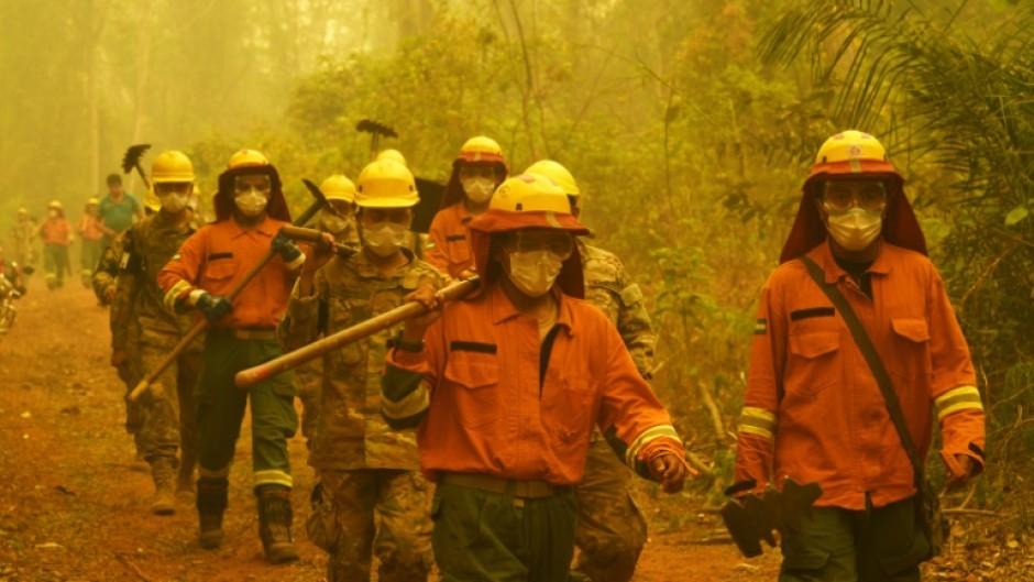 Firefighters arrive at the scene of a fire in Concepcion,  Boliva, on September 24, 2024