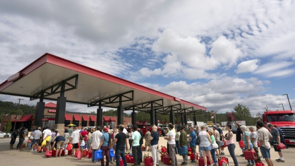 People wait in line for gasoline in the aftermath of Hurricane Helene on September 29, 2024 in Fletcher, North Carolina