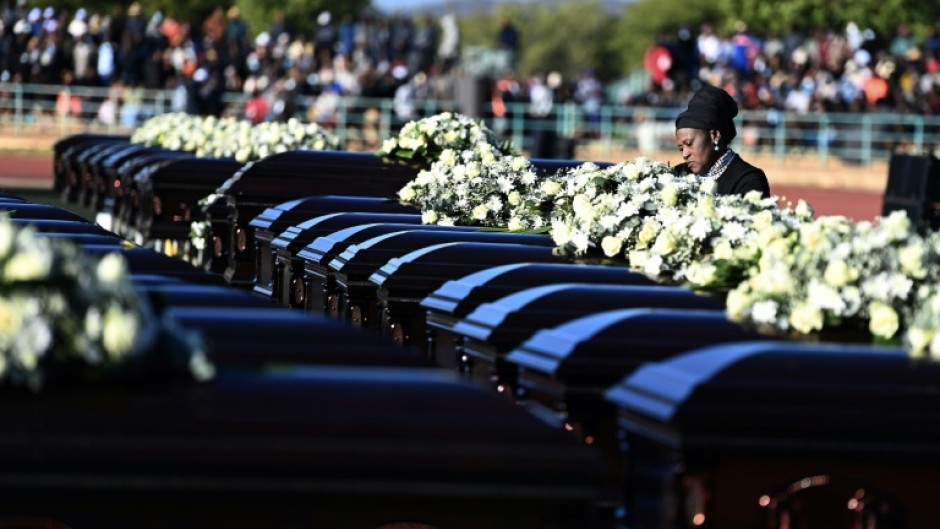 A relative mourns the 45 victims of a bus accident in Botswana in May 