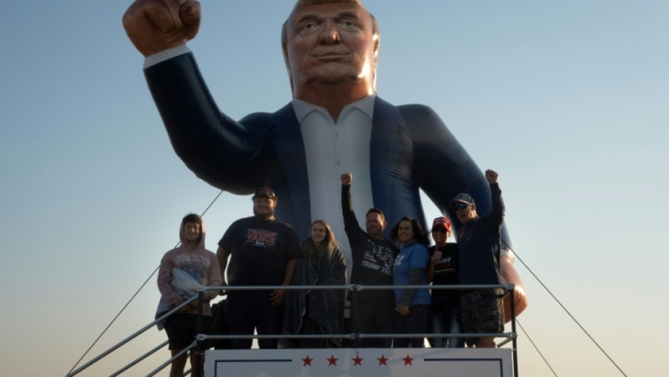 People attend a rally hosted by Republican presidential nominee Donald Trump at Dodge County Airport on October 06, 2024 in Juneau, Wisconsin