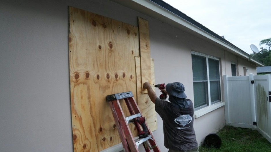 A resident boards up his windows in Palm Harbor, Florida, ahead of Hurricane Milton