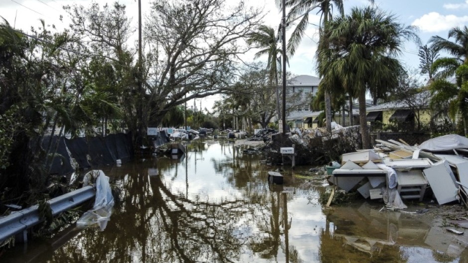 A flooded street with debris in the aftermath of Hurricane Milton in Siesta Key, Florida, where the storm made landfall