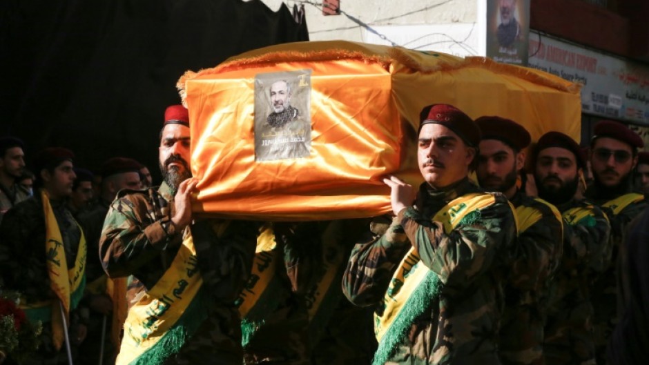 Hezbollah fighters carry the coffin of Mohammed Srur, head of the movement's drone unit, killed on September 26, 2024 in an Israeli strike on Beirut's southern suburbs