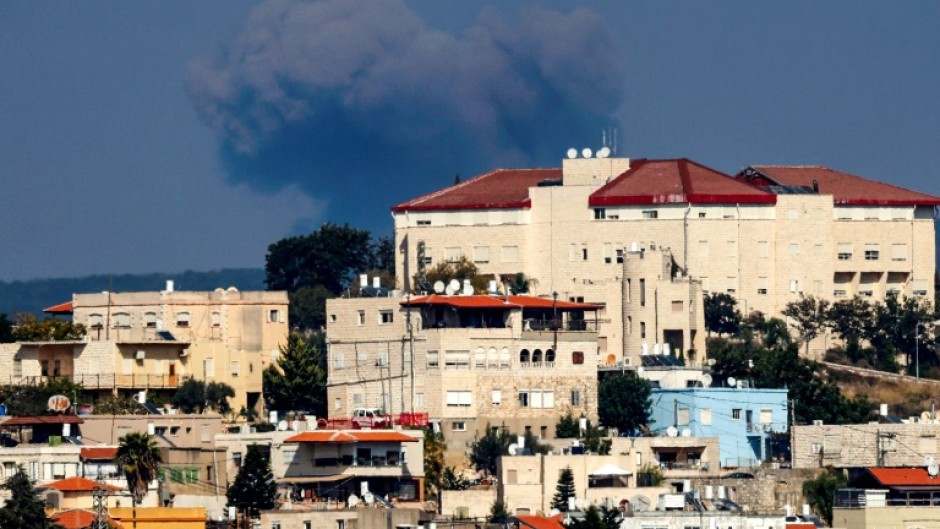 Smoke billows on the Lebanese side of the border following an Israeli air strike, seen from the northern Israeli town of Miilya in the western Galilee 