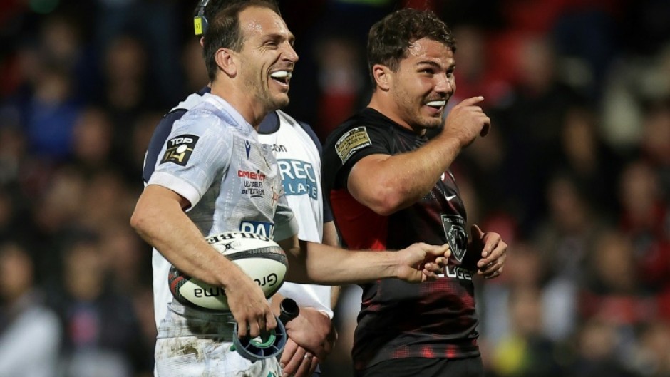 Joy: Antoine Dupont shares a joke with Clermont fly-half Benjamin Urdapilleta 