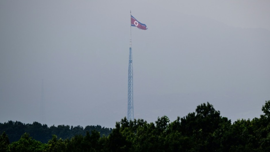 A North Korean flag seen from Paju in South Korea flutters over the village of Gijungdong in July 2024