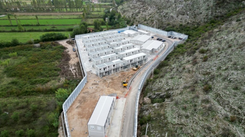 The processing centres are surrounded by high walls and security cameras 