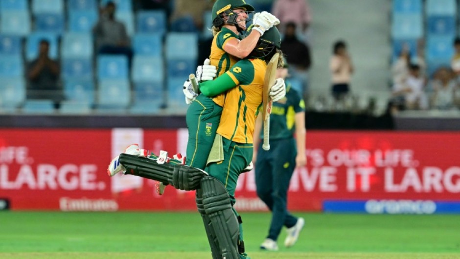 Anneke Bosch (L) leaps into the arms of  Chloe Tryon to celebrate South Africa's eight wicket win over Australia in the semi-final of the Women's T20 World Cup 