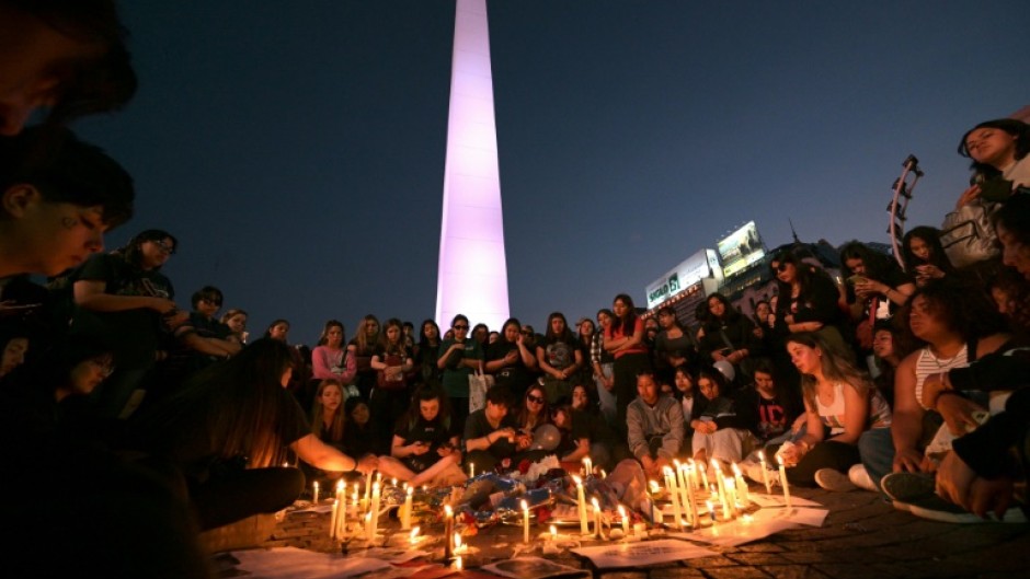 Fans light candles as they pay tribute to the late British singer Liam Payne at the Obelisco in Buenos Aires 