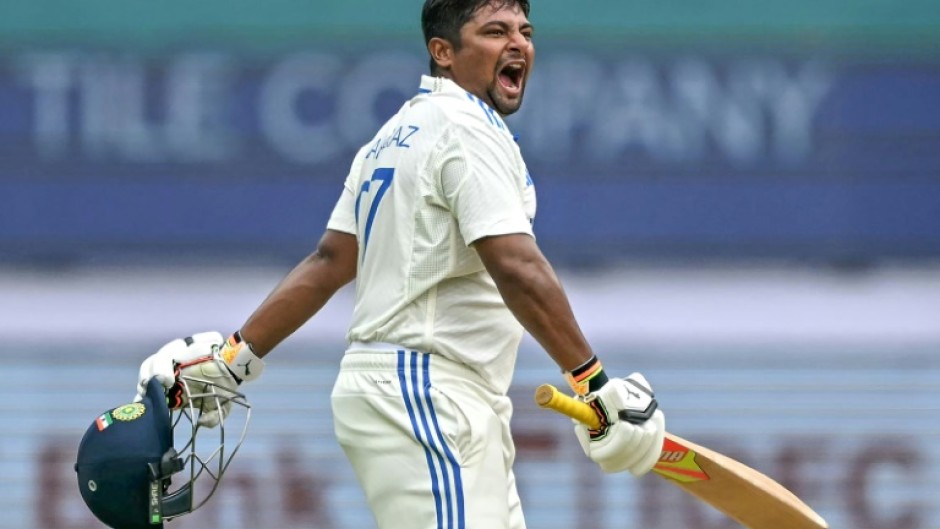 India's Sarfaraz Khan celebrates after scoring a century on the fourth day of the first cricket Test against New Zealand in Bengaluru