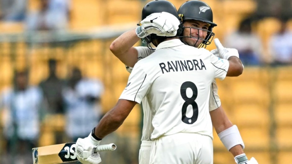 New Zealand's Will Young and Rachin Ravindra celebrate their team's win against India