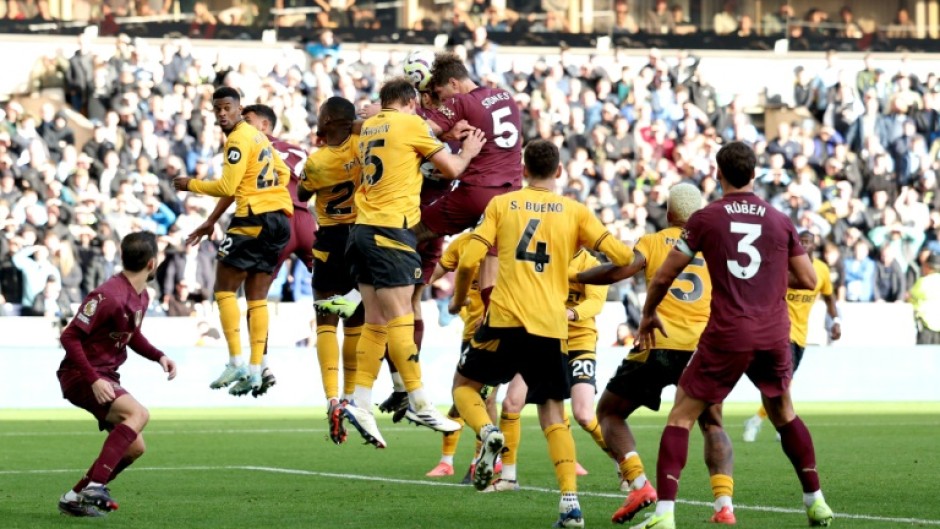 Manchester City's John Stones rises to score the winner against Wolves