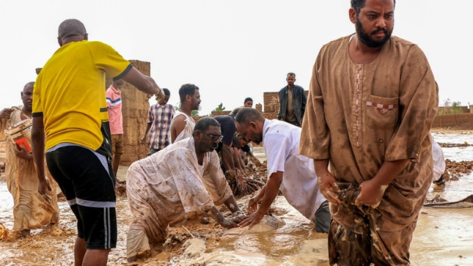 Men building a make-shift levee amid floods in Messawi, Sudan earlier this year