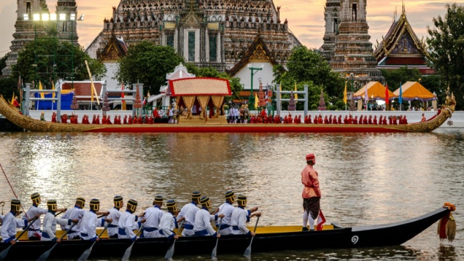 Thousands of well-wishers lined Bangkok's Chao Phraya river Sunday to watch King Maha Vajiralongkorn ride a glittering royal barge procession