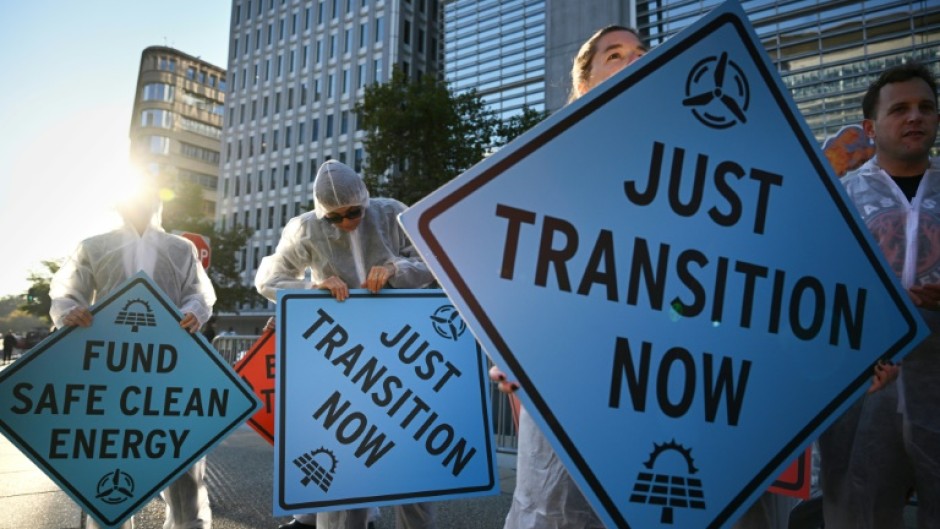 Activists protest against investment in fossil fuels outside of the World Bank headquarters in Washington, DC