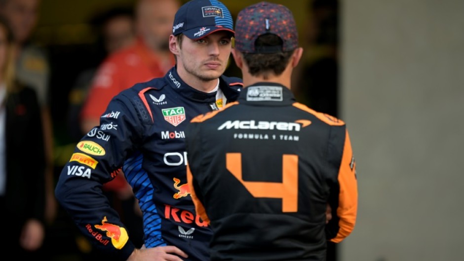 Red Bull Racing's Dutch driver Max Verstappen (L) talks with McLaren's British driver Lando Norris after qualifying for the Mexico Grand Prix