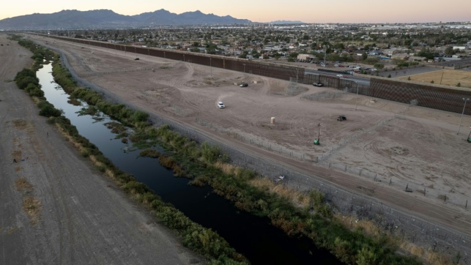 Vehicles guard the US side of the border with Mexico