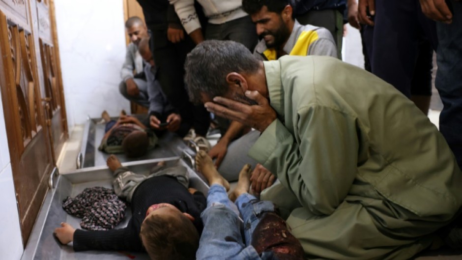 Palestinians at Nasser Hospital in Khan Yunis, southern Gaza, react in front of the bodies of children killed in an Israeli strike