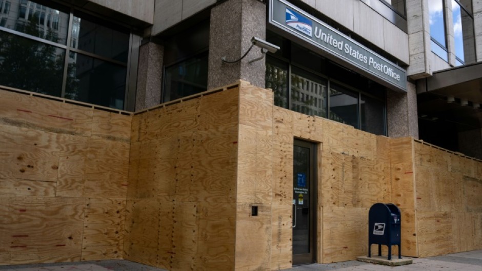 Workers have boarded up storefronts along Pennsylvania Avenue near the White House as the nation's capital braces for potential unrest with a contentious US Election Day looming