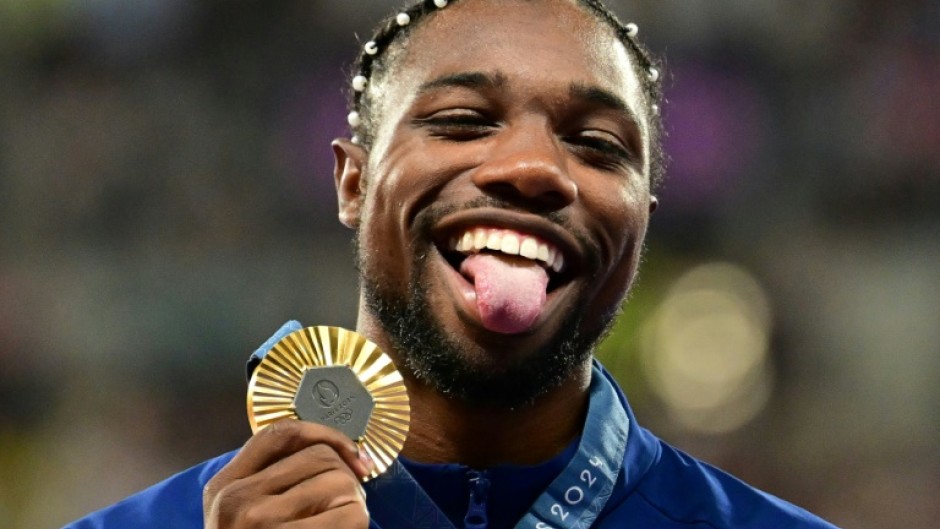 Noah Lyles with his Olympic 100m gold medal - but it wasn't enough to earn him a chance to win the men's track athlete of the year award