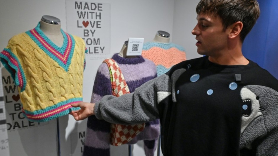 Retired British Olympic diving champion Tom Daley returned to Tokyo, where he won Olympic gold three years ago, to open a showcase of his knitting and crocheting