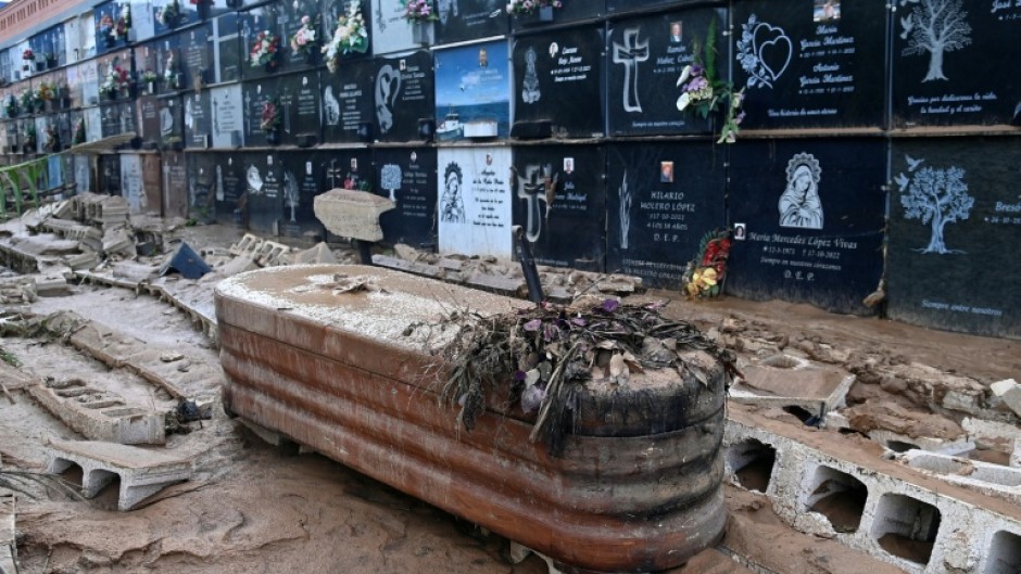 This picture taken on November 1, 2024 shows a coffin covered in mud and debris at a cemetery in the town of Alfafar