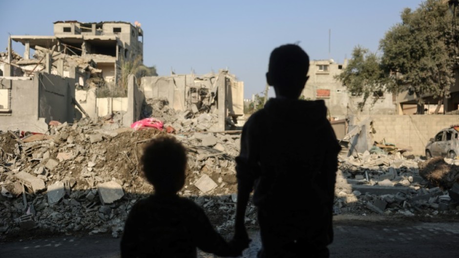 Gazan children stare at destruction from an Israeli strike on Nuseirat refugee camp